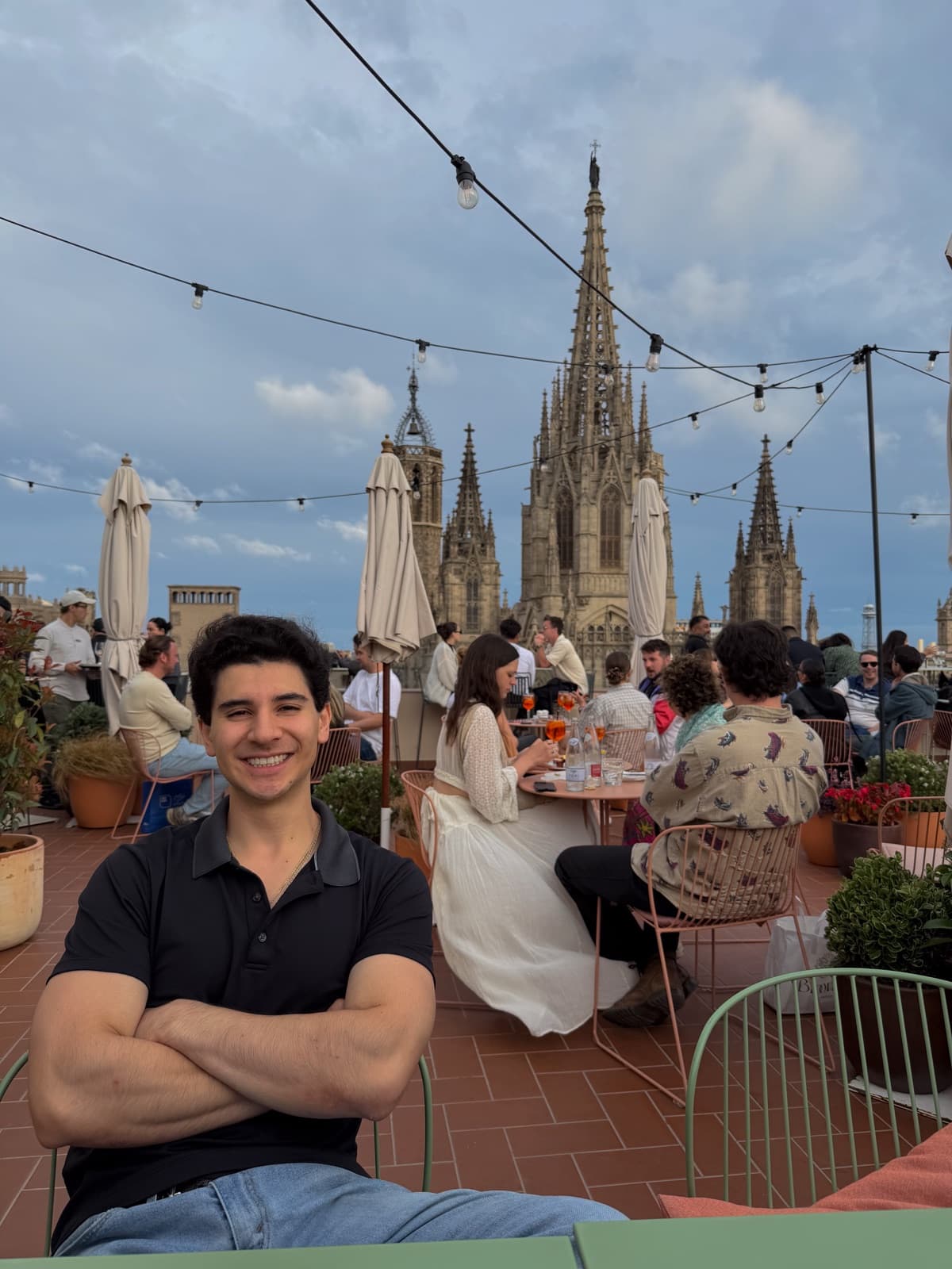 Carter on a rooftop terrace in Barcelona, the cathedral behind him